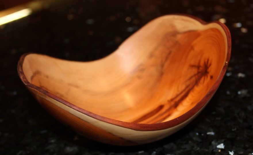 woodworker turns a log into a bowl