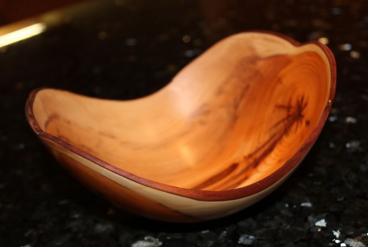 woodworker turns a log into a bowl