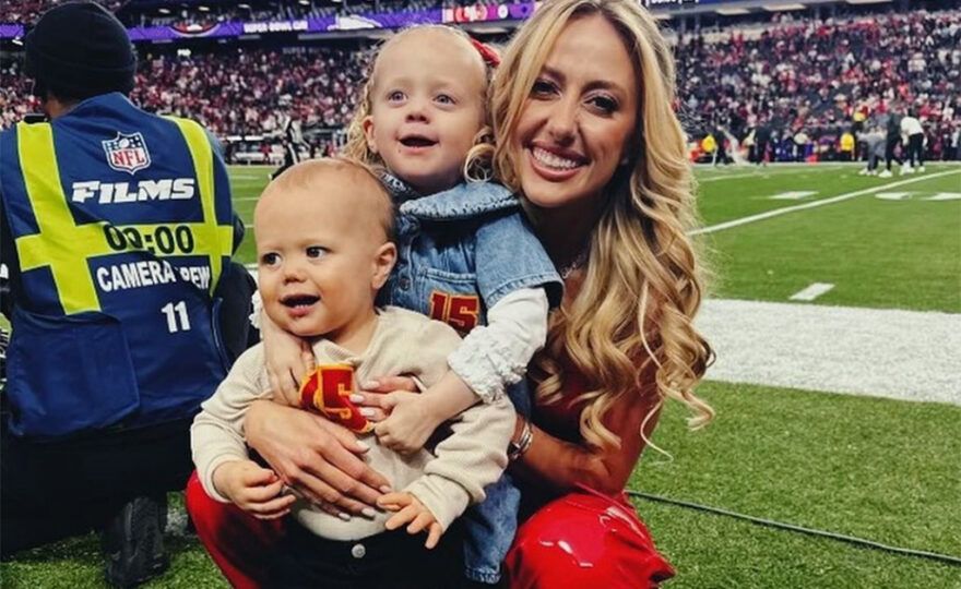 Brittany Mahomes at a football game with her two children.