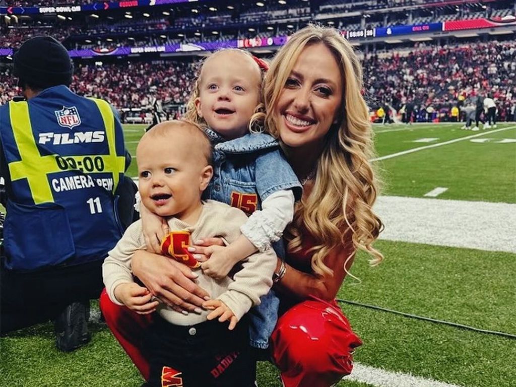 Brittany Mahomes at a football game with her two children.
