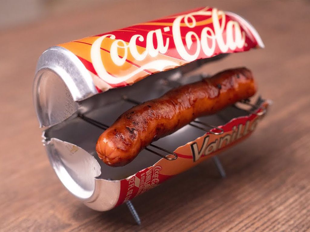 Coca Cola can being used as a makeshift grill