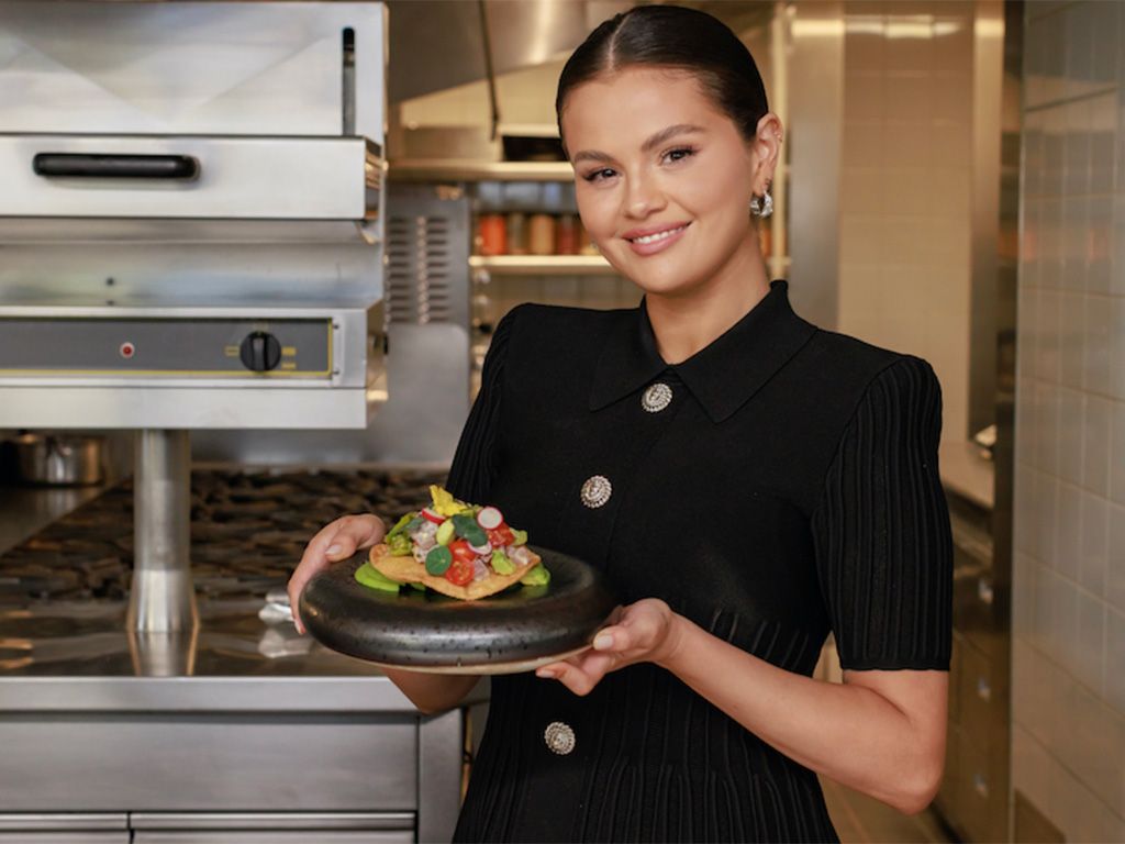 Selena Gomez holding a plate of food