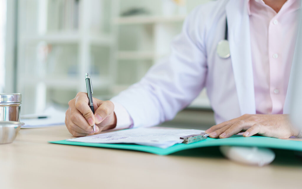 Doctor filling out paperwork
