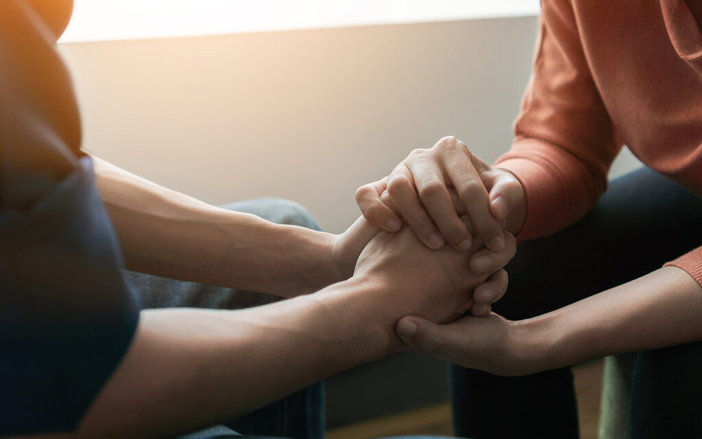 Two people holding hands