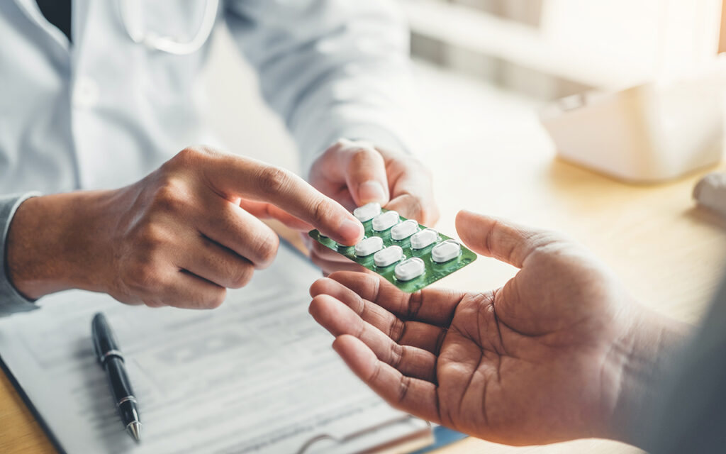 Doctor giving medication to a patient