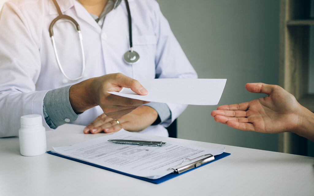 Doctor handing out a prescription