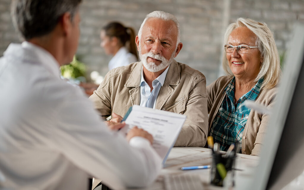 Elderly couple talking to a doctor