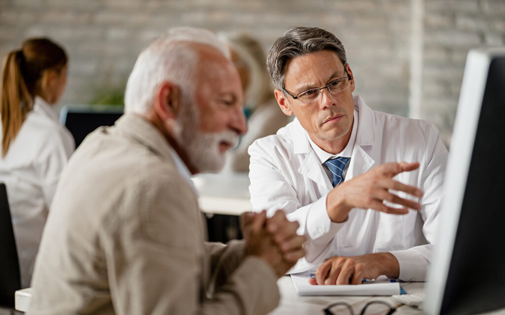 Elderly man talking to a doctor