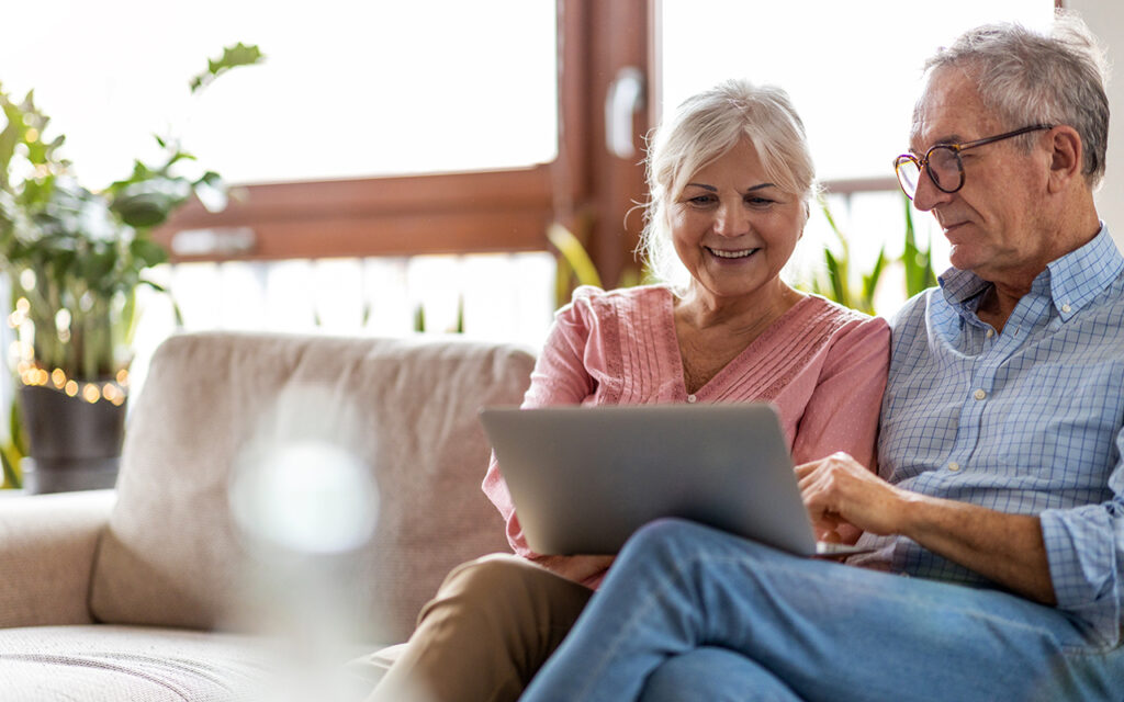 Elderly couple looking at laptop