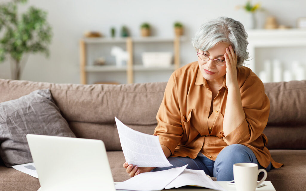 Elderly woman looking at paperwork