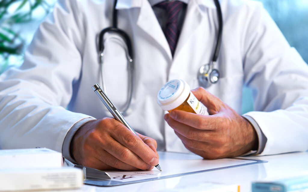 Doctor filling out a prescription