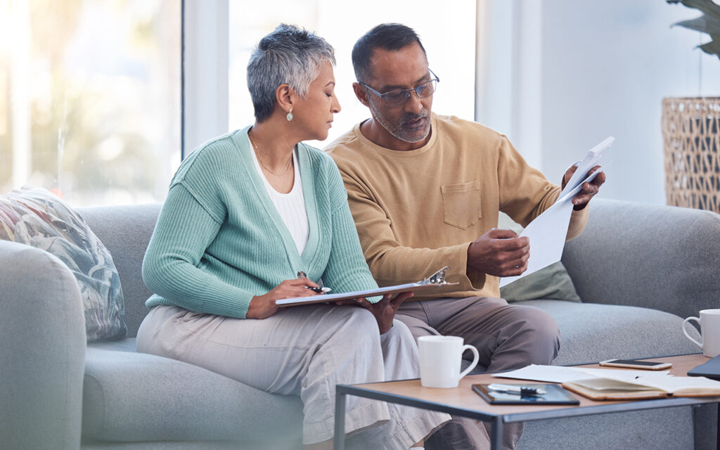 Elderly couple reading paperwork
