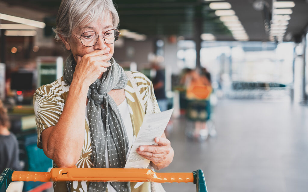 Elderly woman looking at a receipt 