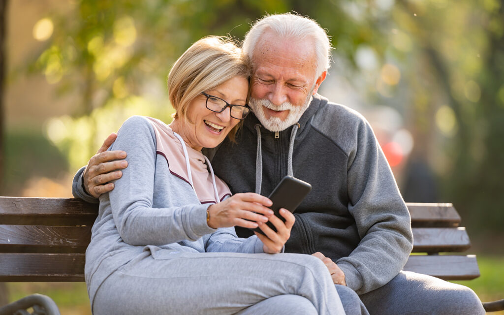 Elderly couple looking at phone