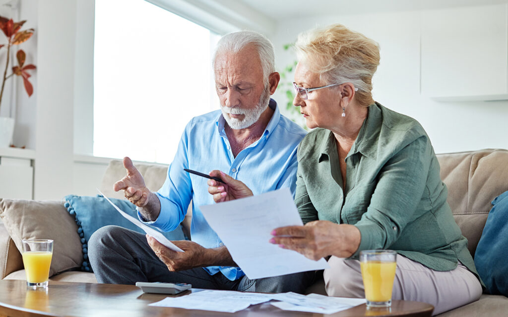 Elderly couple looking at paperwork