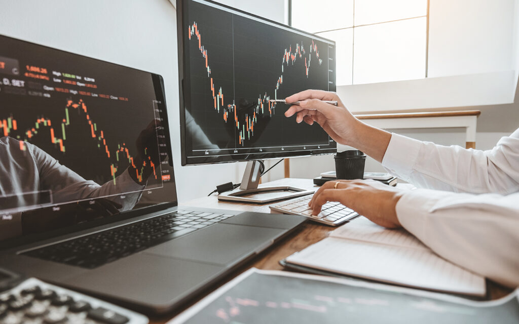 Person looking at stock market on desktop computer