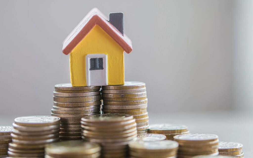 Small house on a pile of coins
