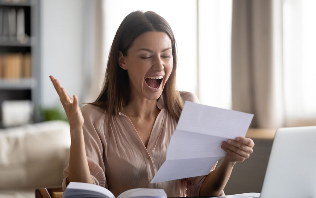 Happy woman reading mail